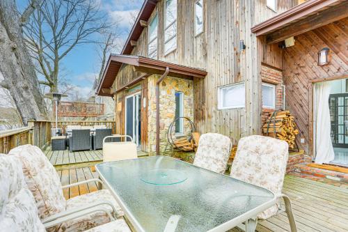a patio with a table and chairs on a deck at Waterfront Lake Hopatcong Home with Boat Dock! in Mount Arlington