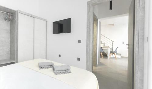 Ένα ή περισσότερα κρεβάτια σε δωμάτιο στο ammouso sun suites