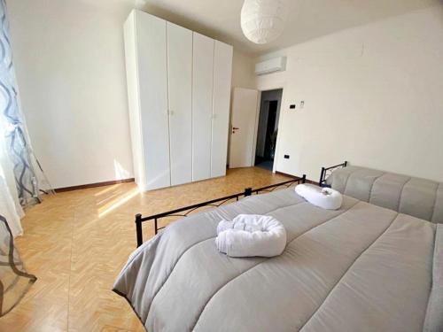 a bedroom with a bed with two towels on it at Giulia home in Monfalcone