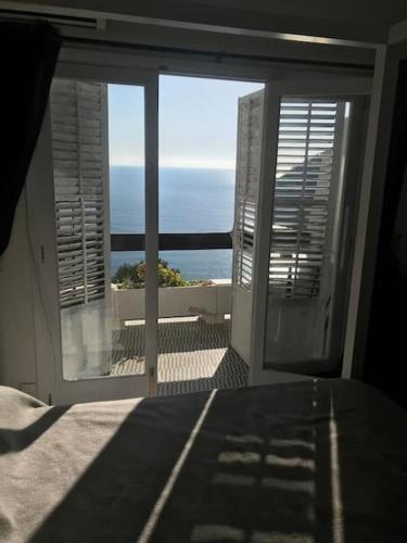 a room with a view of the ocean from a balcony at De Balearibus in Cala Llonga