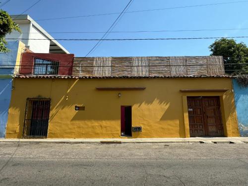 a yellow and blue building on a street at The FLORENTHINA'S House in Oaxaca City