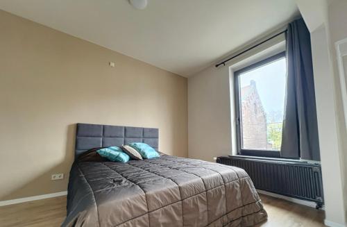 a bedroom with a bed and a large window at Station 64 A3 Bruxelles-Charleroi-airport in Charleroi