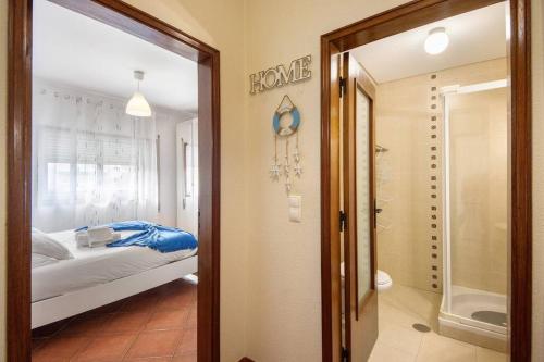 a bedroom with a bed and a walk in shower at Manny's place - by the sea in Gafanha da Nazaré