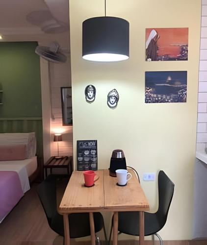 a room with a table with a coffee maker on it at A Joia de Olinda in Olinda