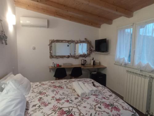 a bedroom with a bed and a desk and a window at Villa Patrizia in La Spezia