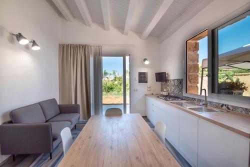 a living room with a table and a couch at Villa del Papiro Charme Apartments in Avola