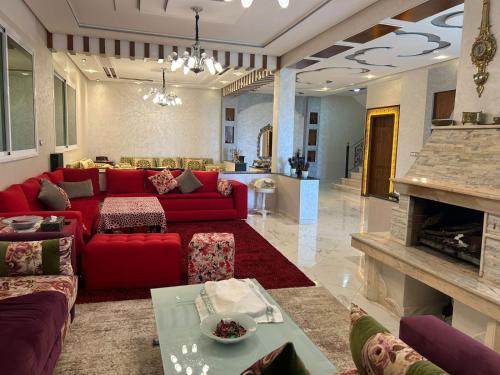 a living room with a red couch and a table at La Perla Montaña Tanger in Tangier