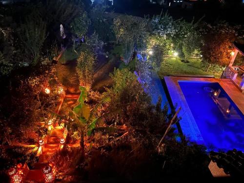 an overhead view of a swimming pool at night at La Perla Montaña Tanger in Tangier