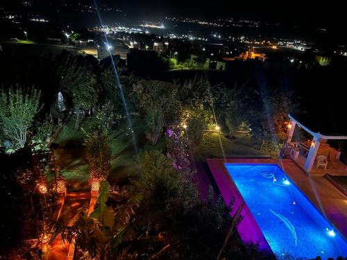 an overhead view of a swimming pool at night at La Perla Montaña Tanger in Tangier