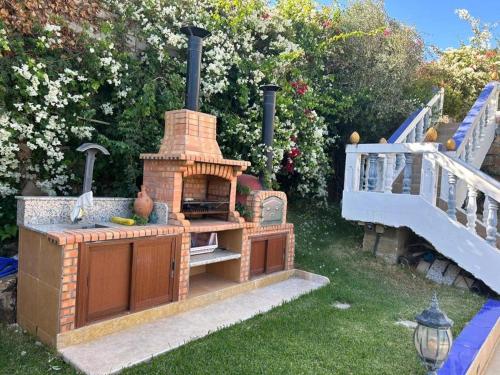 a brick oven in the grass next to a bridge at La Perla Montaña Tanger in Tangier