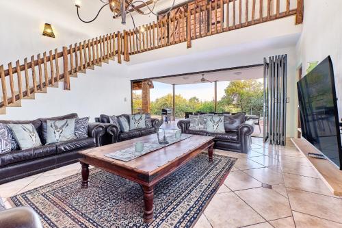 a living room with a couch and a table at Shasha Lodge, Mabalingwe Game Reserve in Mabula