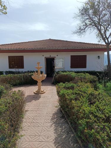 a house with a fountain in front of it at Casa Rural Chalet Venta del Aire Cortijo Terron in Lanjarón
