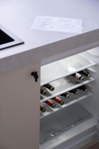 a refrigerator filled with lots of bottles of wine at B&B De Joker in Turnhout