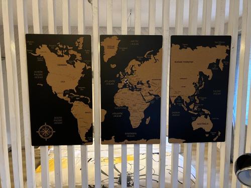 two maps of the world hanging on a crib at Au numéro 12 