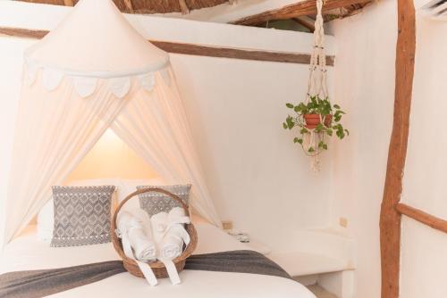 a room with a bed with a canopy at Casa Takywara in Holbox Island
