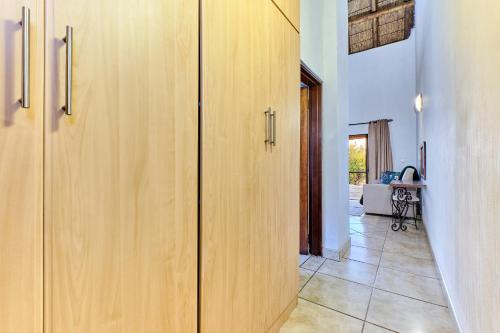 a hallway with wooden cabinets in a house at Shasha Lodge, Mabalingwe Game Reserve in Mabula