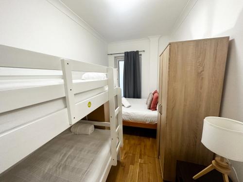 a small room with a bunk bed and a small bedroom at Grays apartment in London