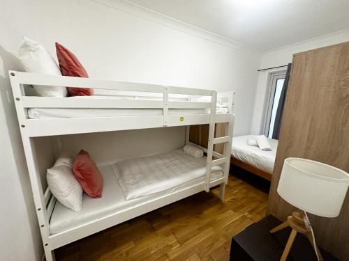 a room with two bunk beds and a bed at Grays apartment in London