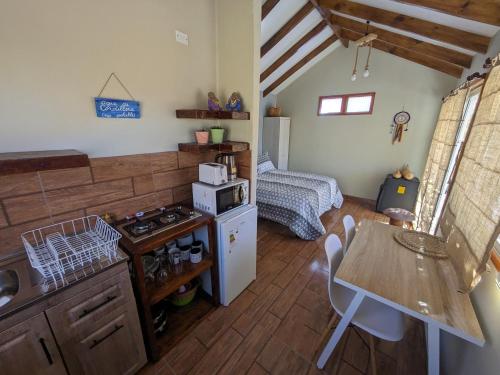 a kitchen with a stove and a bed in a room at Cumbres de Alcohuaz in Alcoguaz