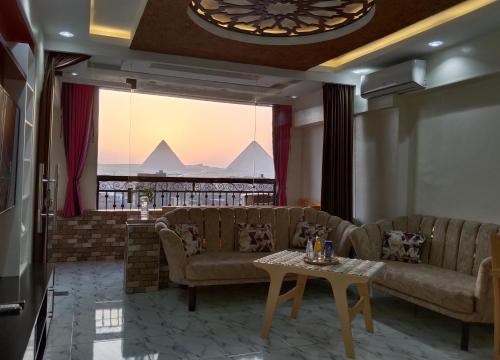 a living room with couches and a table at Isis Guest House in Cairo