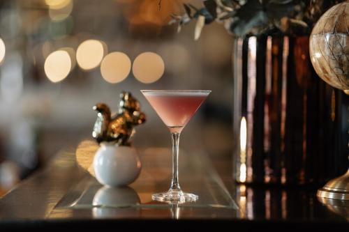 a drink in a glass sitting on a table at Vimmerby Stadshotell, WorldHotels Crafted in Vimmerby
