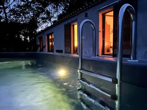 a house with a swimming pool at night at Villa Casa Papey in Draguignan