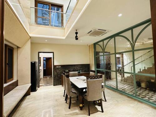 a dining room with a table and chairs at Ultra luxury 5BHK duplex in Kondapur in Kondapur