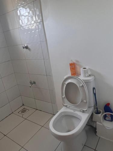 a bathroom with a toilet and a shower at Gianna’s Stays in Mombasa