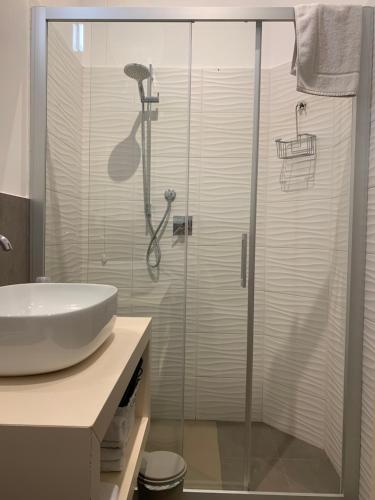 a bathroom with a glass shower with a sink at B&B PREVISTO SOLE in Civitanova Marche