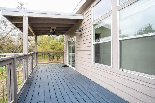 a porch of a house with a wooden deck at Serene Hill Country Home w/ Romantic Garden Escape in Driftwood