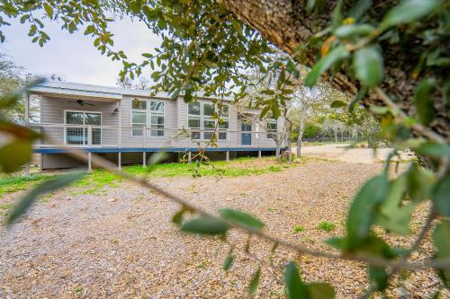 a house in the middle of a yard at Serene Hill Country Home w/ Romantic Garden Escape in Driftwood