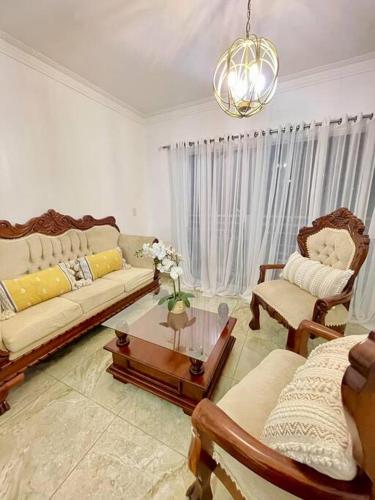 a living room with a couch and a table at Super Cozy n´Confortable apart. in Ensanche Los Minas