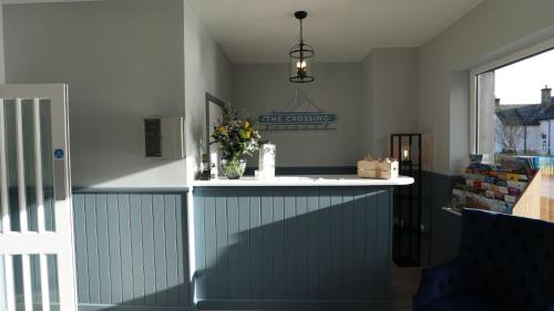 a kitchen with a counter with flowers on it at The Crossing in Kingussie