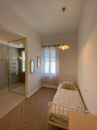 a bedroom with a bed and a large mirror at Merveilleuse maison de village in Maillane
