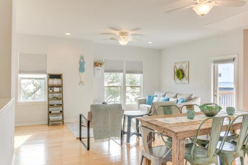 a dining room and living room with a table and chairs at Seabrook Getaway with Balconies and Bay Views! in Seabrook