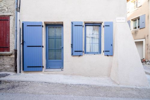 a building with blue shutters on the side of it at La Barule in Charols