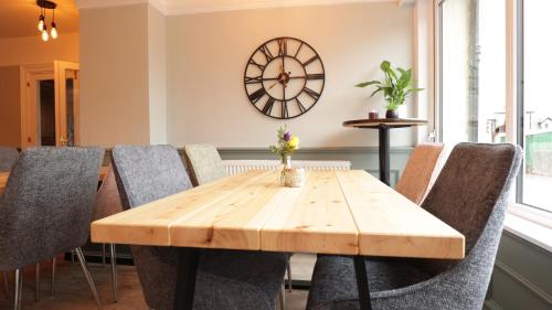 a dining room with a wooden table and chairs at The Crossing in Kingussie