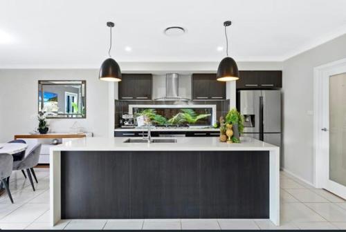 a kitchen with a large island in the middle at Happy life in Schofields