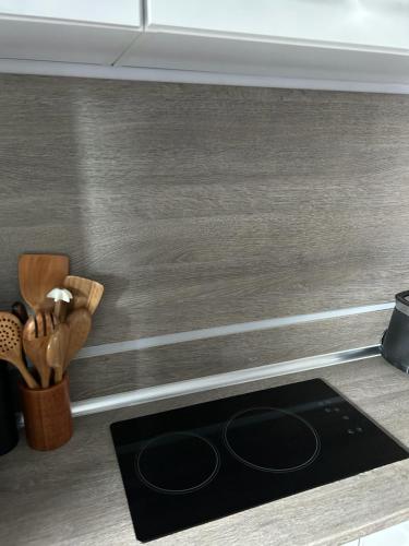 a kitchen counter with a black stove top at Bungalow Schwarzatalblick in Bad Blankenburg Ortsteil Böhlscheiben in Bad Blankenburg