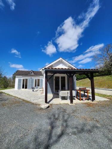 une petite maison avec un pavillon en face de celle-ci dans l'établissement Maison de campagne, au calme., à Carlux