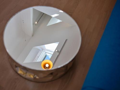a mirror with an orange sitting on top of a table at Haus Fünf mit 2 Apartments und Studio-Loft mit Terrasse in Melk