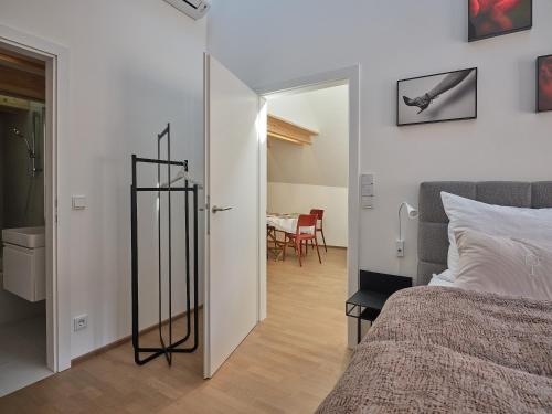 a bedroom with a bed and a room with a table at Haus Fünf mit 2 Apartments und Studio-Loft mit Terrasse in Melk