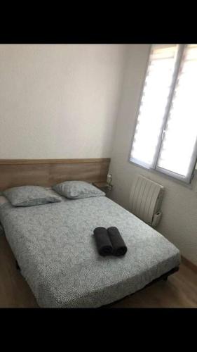 - une chambre dotée d'un lit avec une paire de chaussures dans l'établissement « Le petit Bastille»Proche Lyon centre, à Villeurbanne