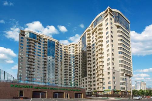 a large white building with a sign on it at Odesa Pearl Apartments in Odesa