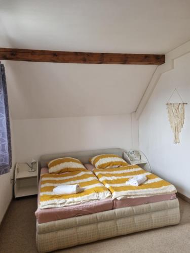 a bedroom with a bed with pillows on it at Haus an der Drau in Feistritz im Rosental