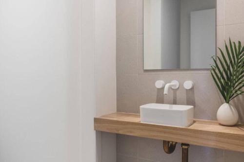 a bathroom with a sink and a mirror at The Ace - Byron Bay in Byron Bay