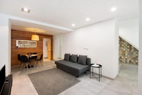 a living room with a couch and a table at São Roque Sweet Burgo in Aveiro