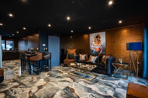 a lobby with a couch and a bar in a room at Highlights Views, Overlooking Mouth of the Tyne in Tynemouth