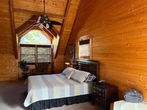 a bedroom with a bed and a ceiling fan at Airport Runway 33 in Pigeon Forge