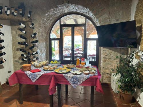 a table with food on it in a room at La Locanda del Curato Rooms in Lentiscosa